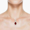 Oval-Cut Ruby Halo Pendant in 14K Yellow Gold with Diamond-Set "X" Bale