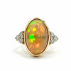 Prism of Light Opal Cabochon with Oval Ruby Surround In Diamond