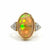 Prism of Light Opal Cabochon with Oval Ruby Surround In Diamond