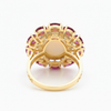 Prism of Light Opal Cabochon with Oval Ruby Surround In Diamond