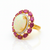 Prism of Light Opal Cabochon with Oval Ruby Surround In Diamond