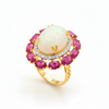 Prism of Light Opal Cabochon with Oval Ruby Surround In Diamond